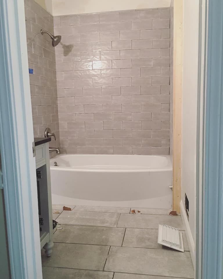 Bathroom remodel: floor-to-ceiling gray subway tile tub surround and new tile floor