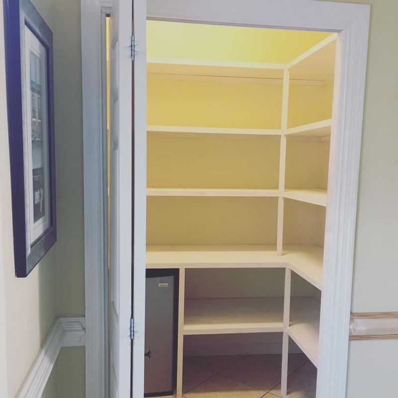 Custom built-in pantry with floor-to-ceiling shelving and organized storage