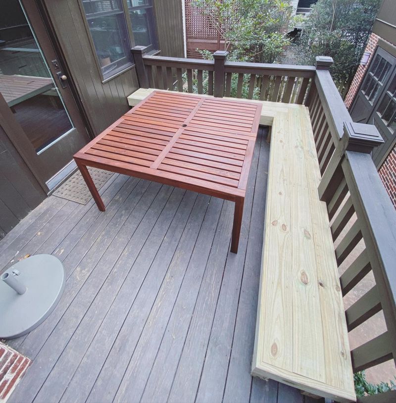 Built-in L-shaped deck bench alongside outdoor dining table