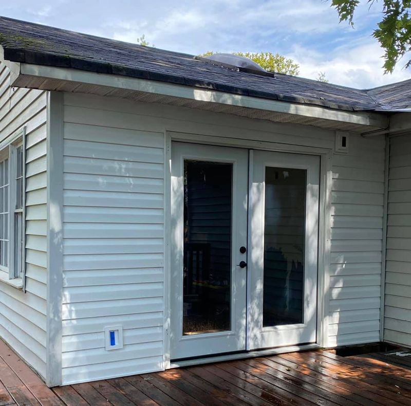 Home exterior with new vinyl siding, french patio door, and exterior electrical outlet