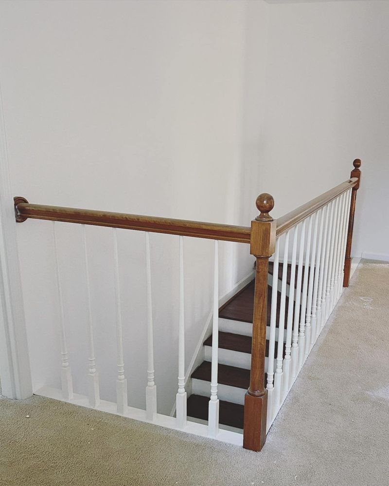 Dated staircase railing with ball-top newel post and turned spindles