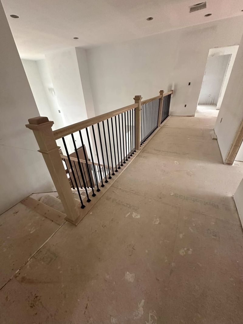Loft-style upper hallway railing with oak and iron balusters
