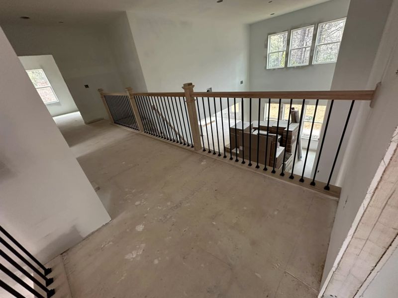 Second floor railing system overlooking open-concept living area