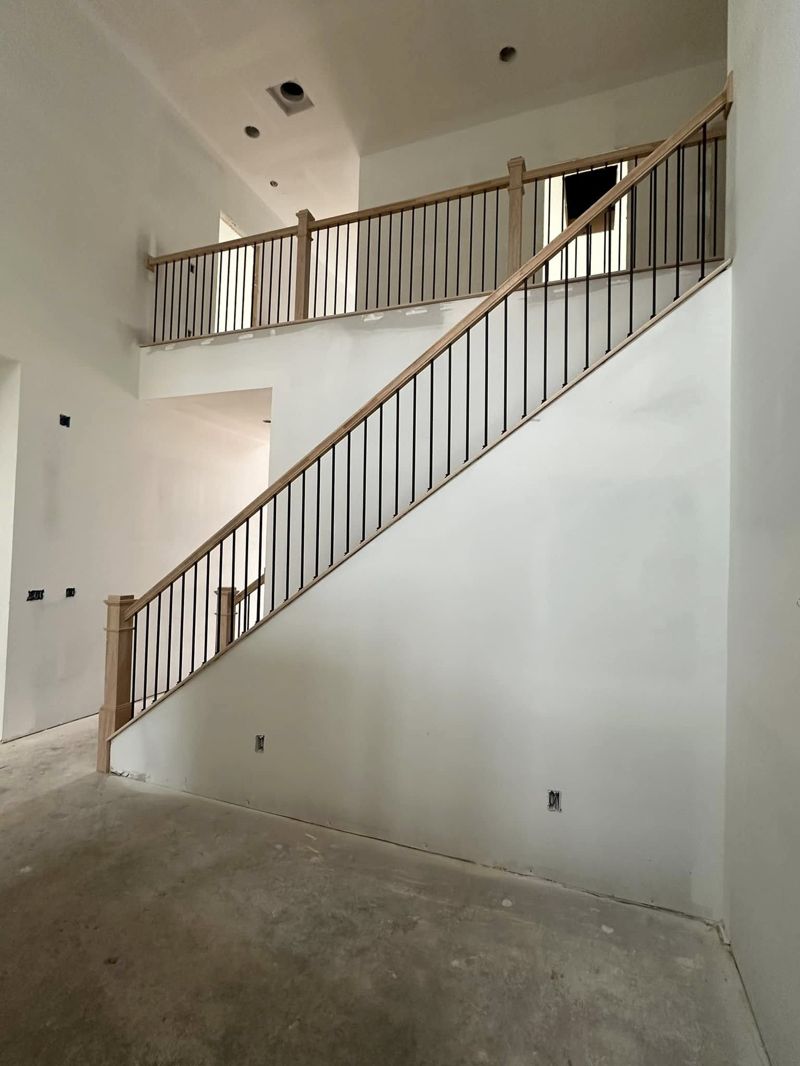 Full stair run from main floor showing seamless railing flow to upper landing