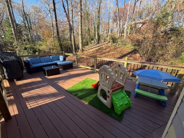 Composite deck with cedar-tone decking and black iron balusters