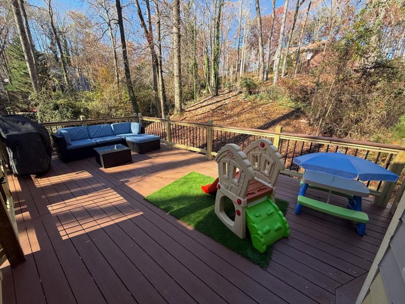 New expansive composite deck with cedar-tone decking and black iron balusters
