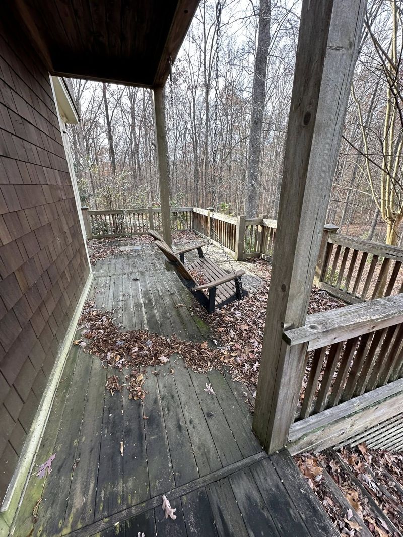 Weathered deck with grayed-out wood and rotting stair treads