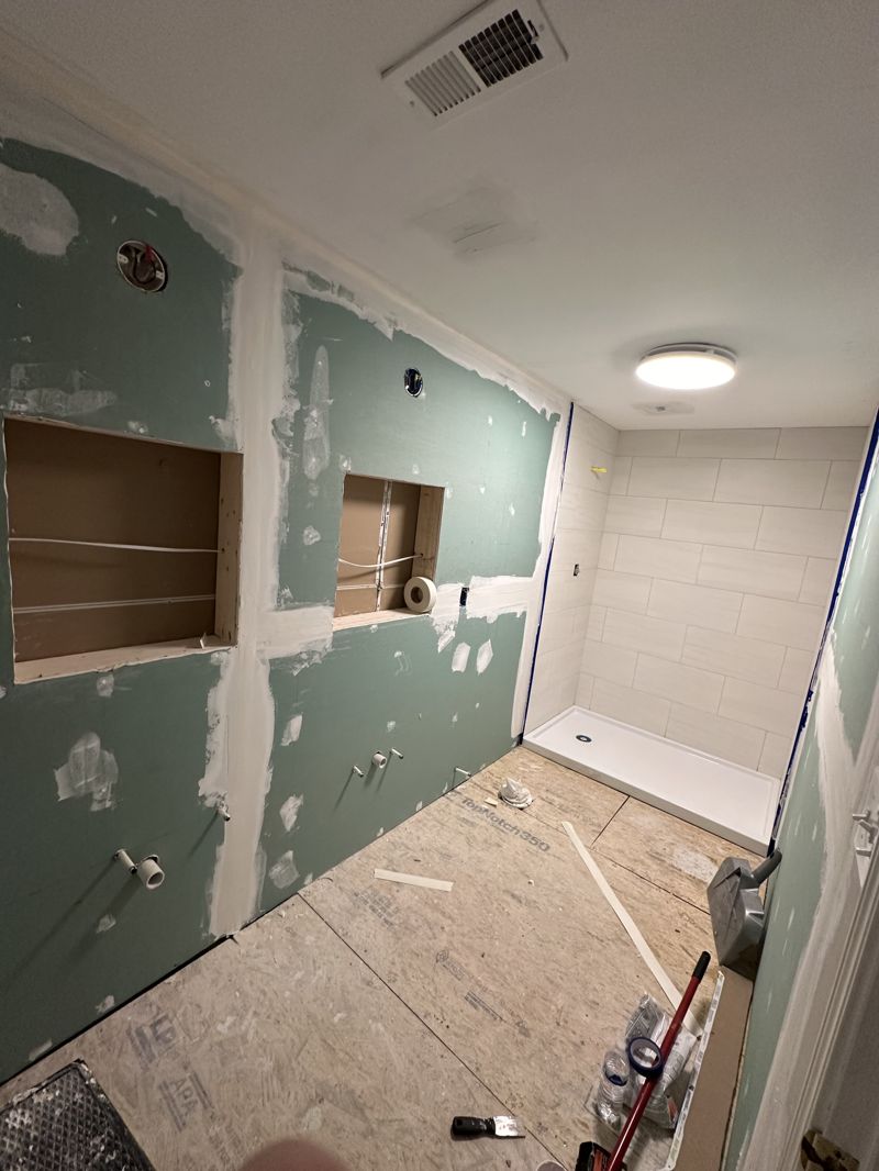 Bathroom framing with moisture barrier installed during full rebuild