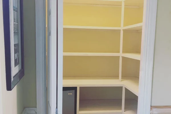 Custom built-in pantry with floor-to-ceiling shelving and organized storage