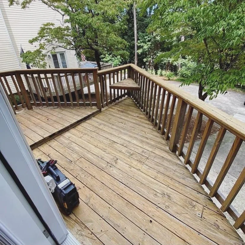 Worn-out wood deck in Roswell with cupping boards and wobbly railing before rebuild