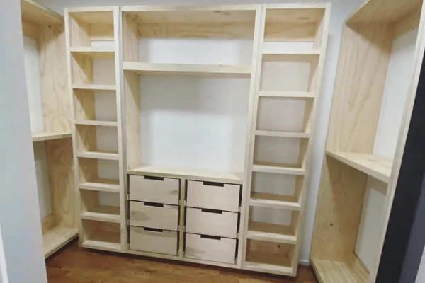 Custom built-in closet with floor-to-ceiling shelving and hanging sections