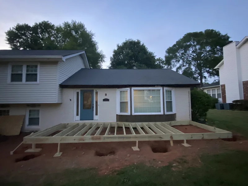 Front porch deck framing on pier footings spanning the front of the home