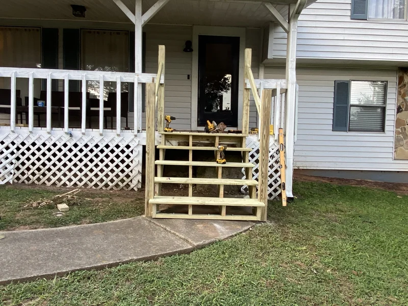 New stair stringers and treads built in place at the front porch, before handrails