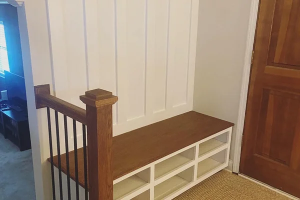 Hall tree and staircase railing with matching oak finish and black iron balusters