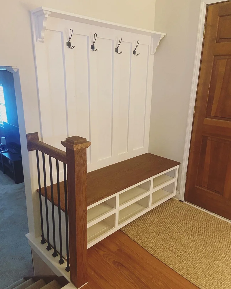 Hall tree and staircase railing with matching oak finish and black iron balusters