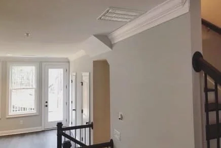 Crown molding installation at room corner with clean mitered profile