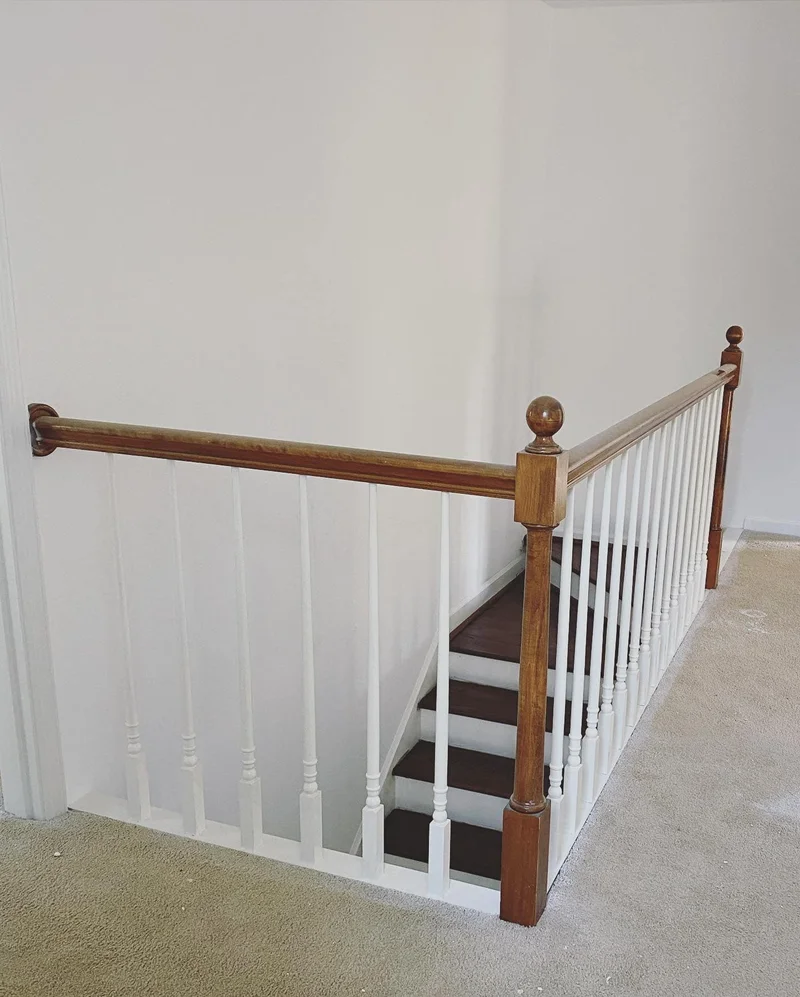 Dated staircase railing with ball-top newel post and turned spindles
