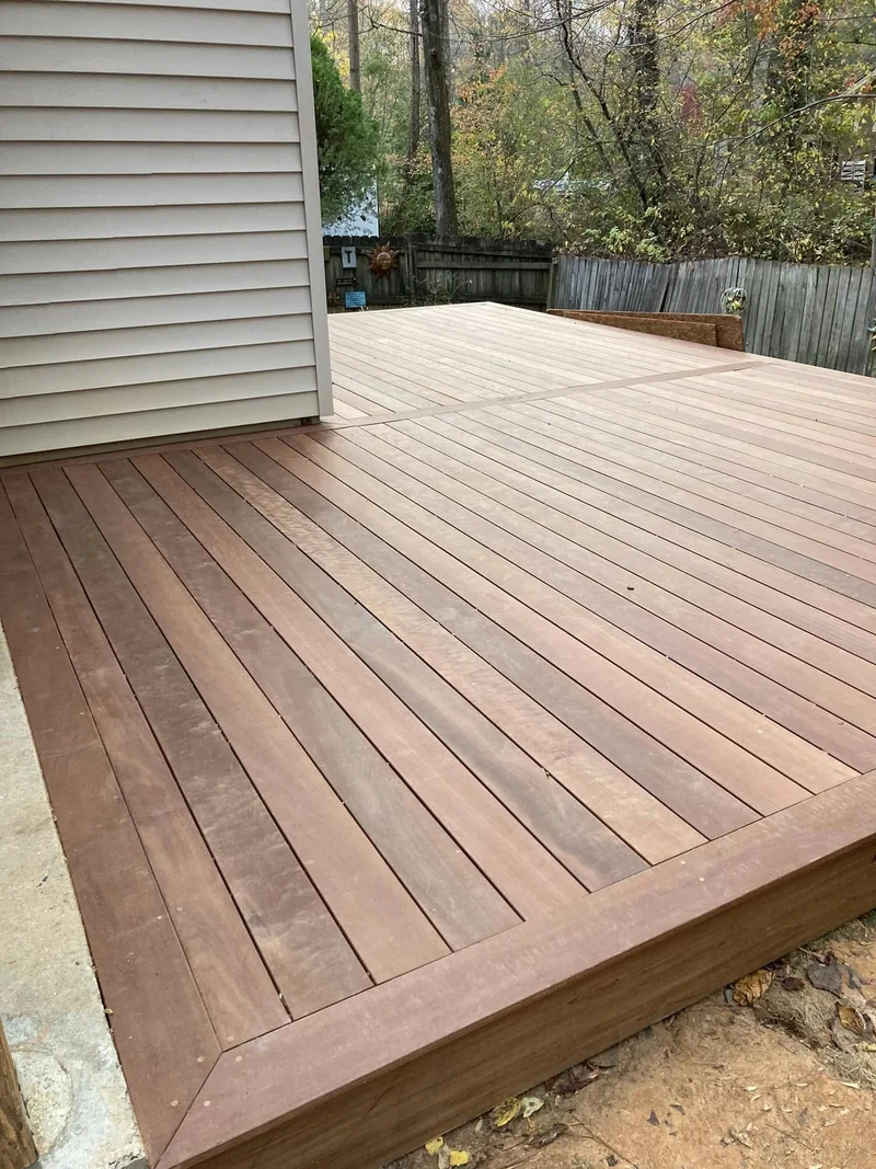 Brazilian hardwood deck construction in wooded backyard