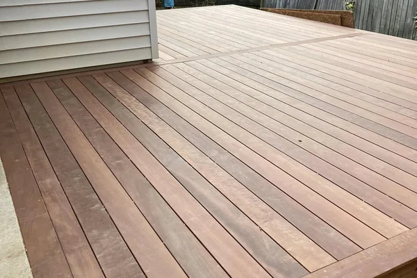 Brazilian hardwood deck construction in wooded backyard
