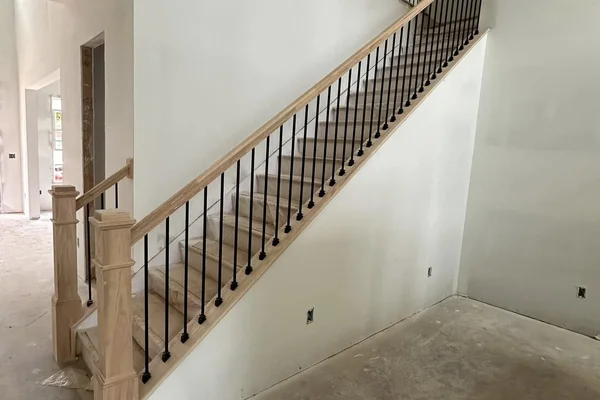 Craftsman newel posts with matte black iron balusters
