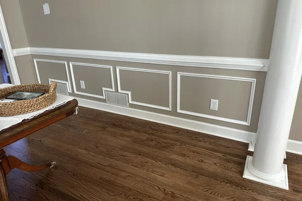 Foyer wainscoting with painted white turned balusters and patterned runner