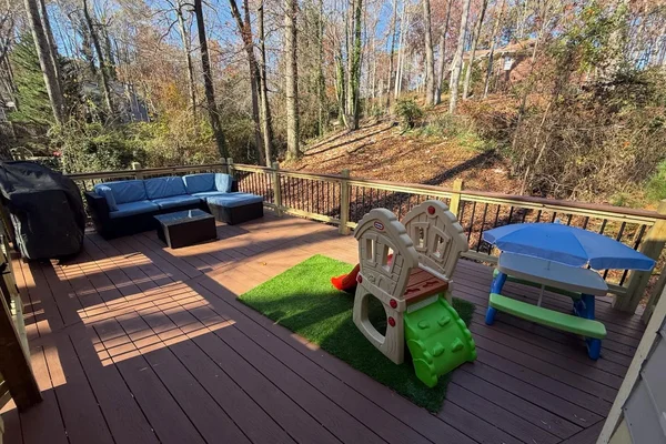 New expansive composite deck with cedar-tone decking and black iron balusters